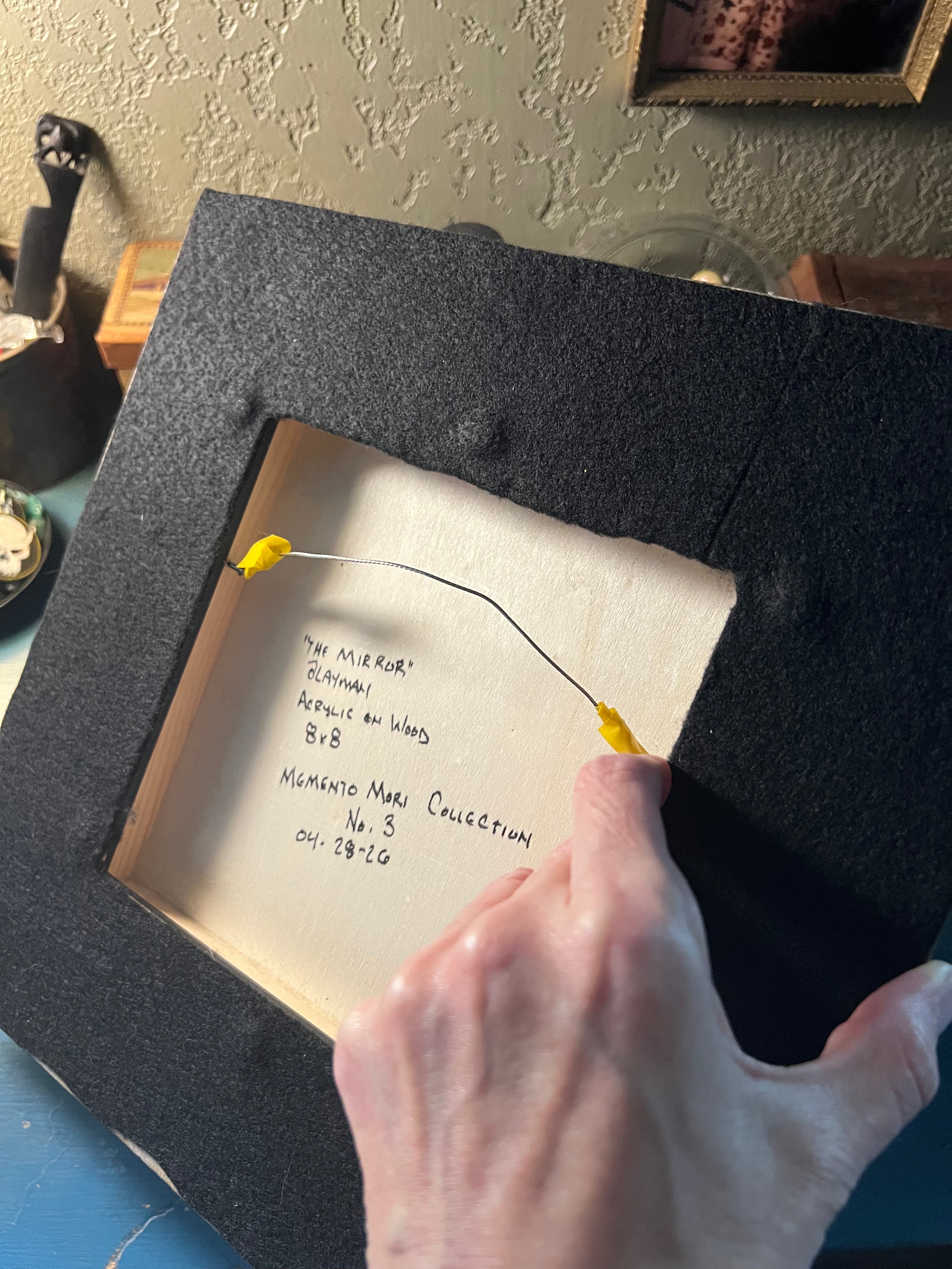 The back of the painting is displayed, showing a felted backing of the wooden painting.  Titled, signed and dated by aLayman.