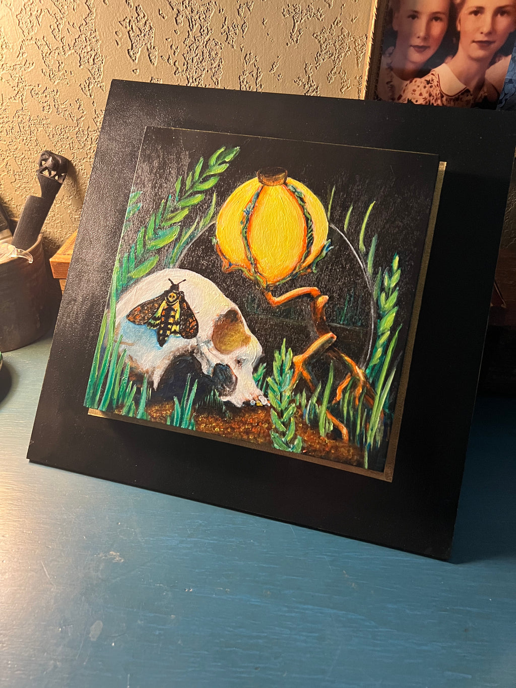 Memento Mori Skull Painting with a lamp, mirror and moth. This painting is by aLayman