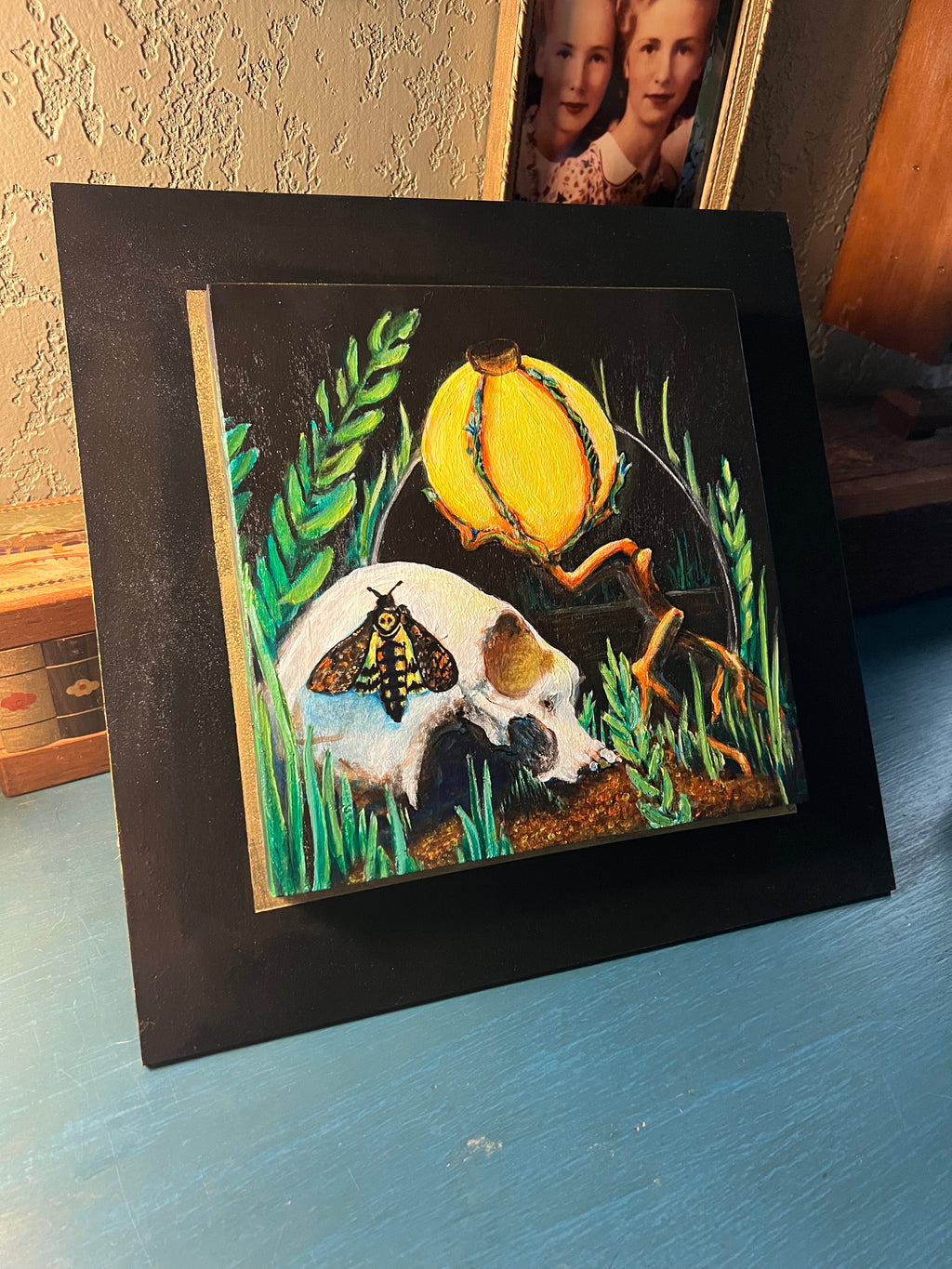 Memento Mori Skull Painting with a lamp, mirror and moth. This painting is by aLayman