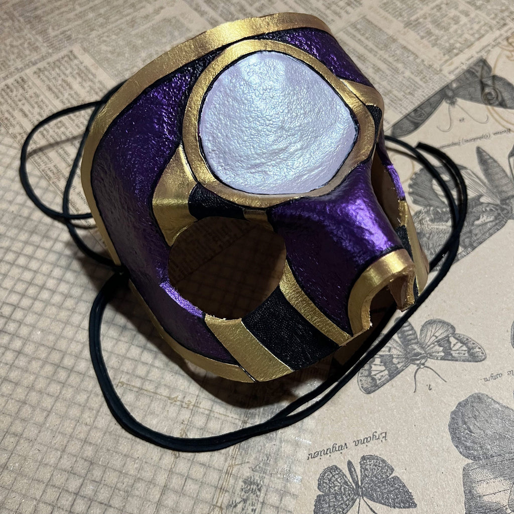 A purple and gold fantasy-style mask.